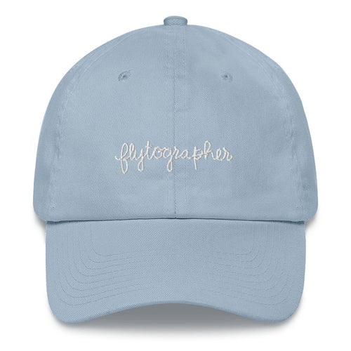 Light blue baseball cap has a low profile with an adjustable strap and curved visor.