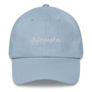Light blue baseball cap has a low profile with an adjustable strap and curved visor.