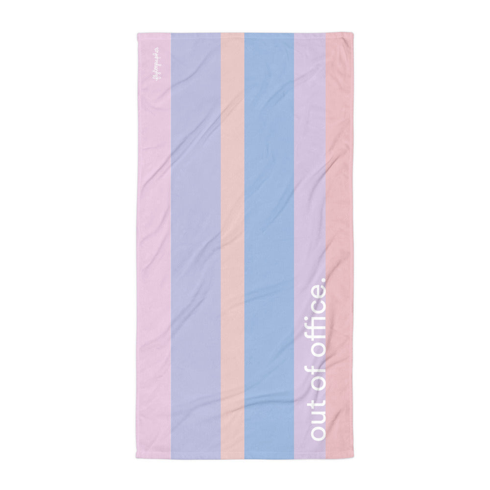 Beach towel in a colourful stripe pattern and words 